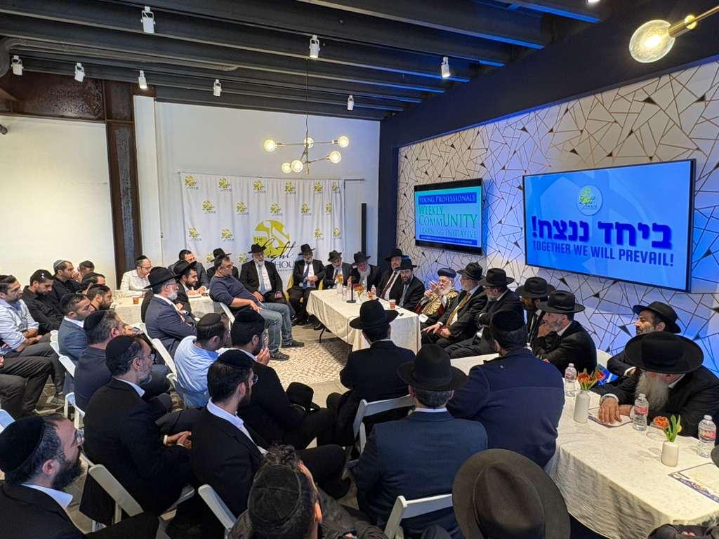 Community members learning Torah together around a table